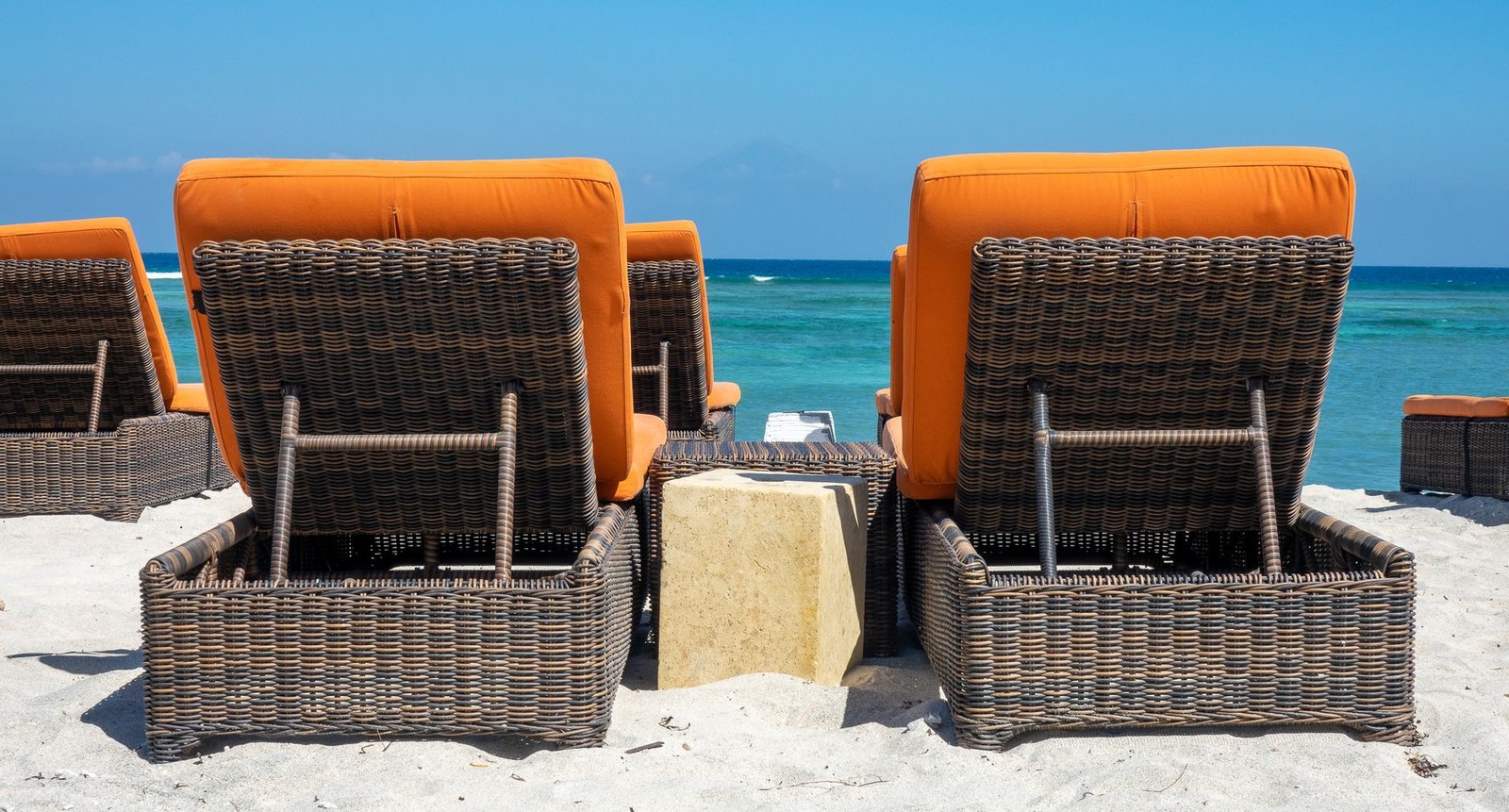 China outdoor seating: wicker sofa set with armchairs and cushions on a paved terrace