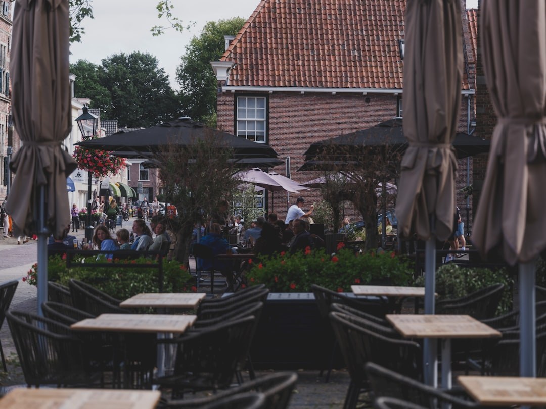 Outdoor cafe seating with parasols on a commercial terrace used for daily service