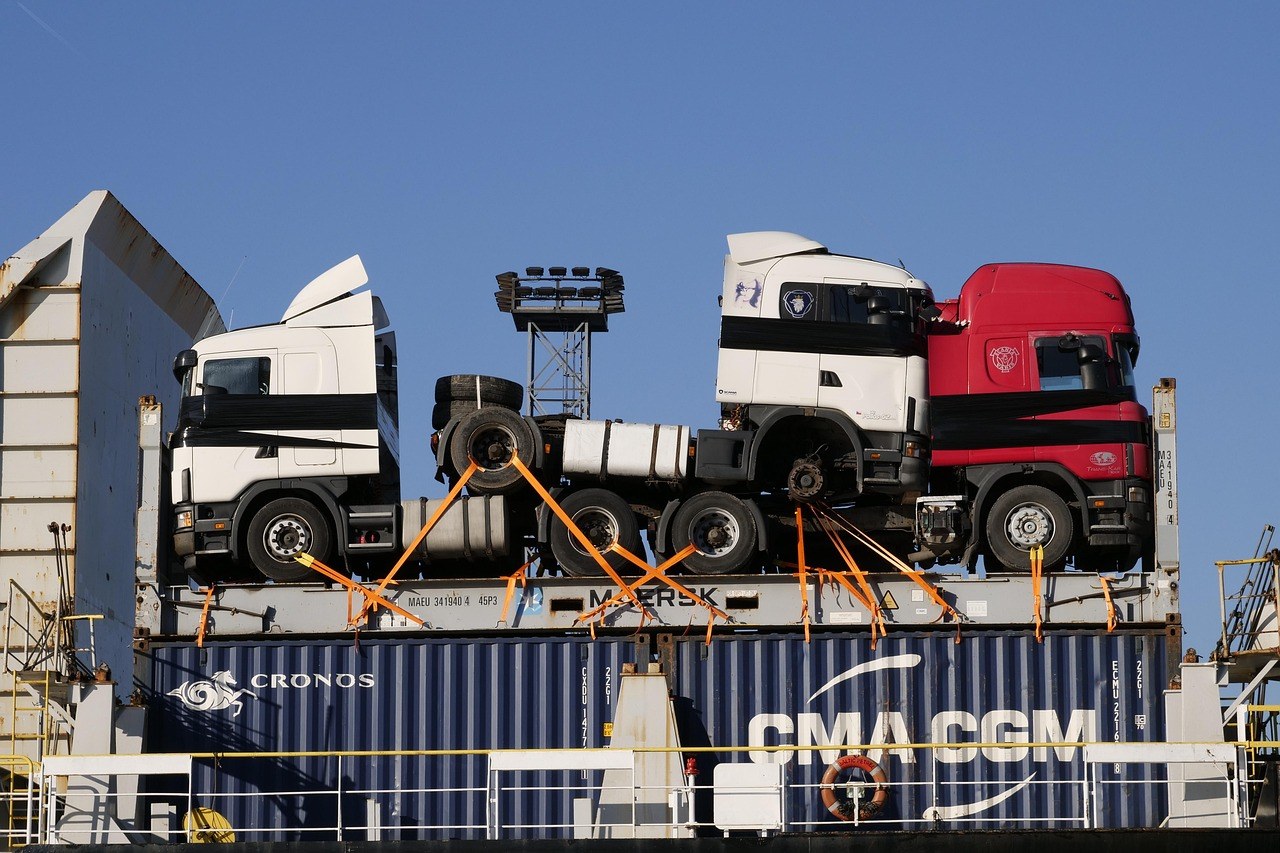 Container terminal with stacked export containers and a container ship at berth