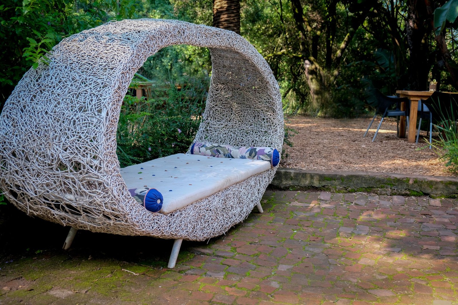 Rattan outdoor daybed with canopy on a hotel pool deck, buying guide