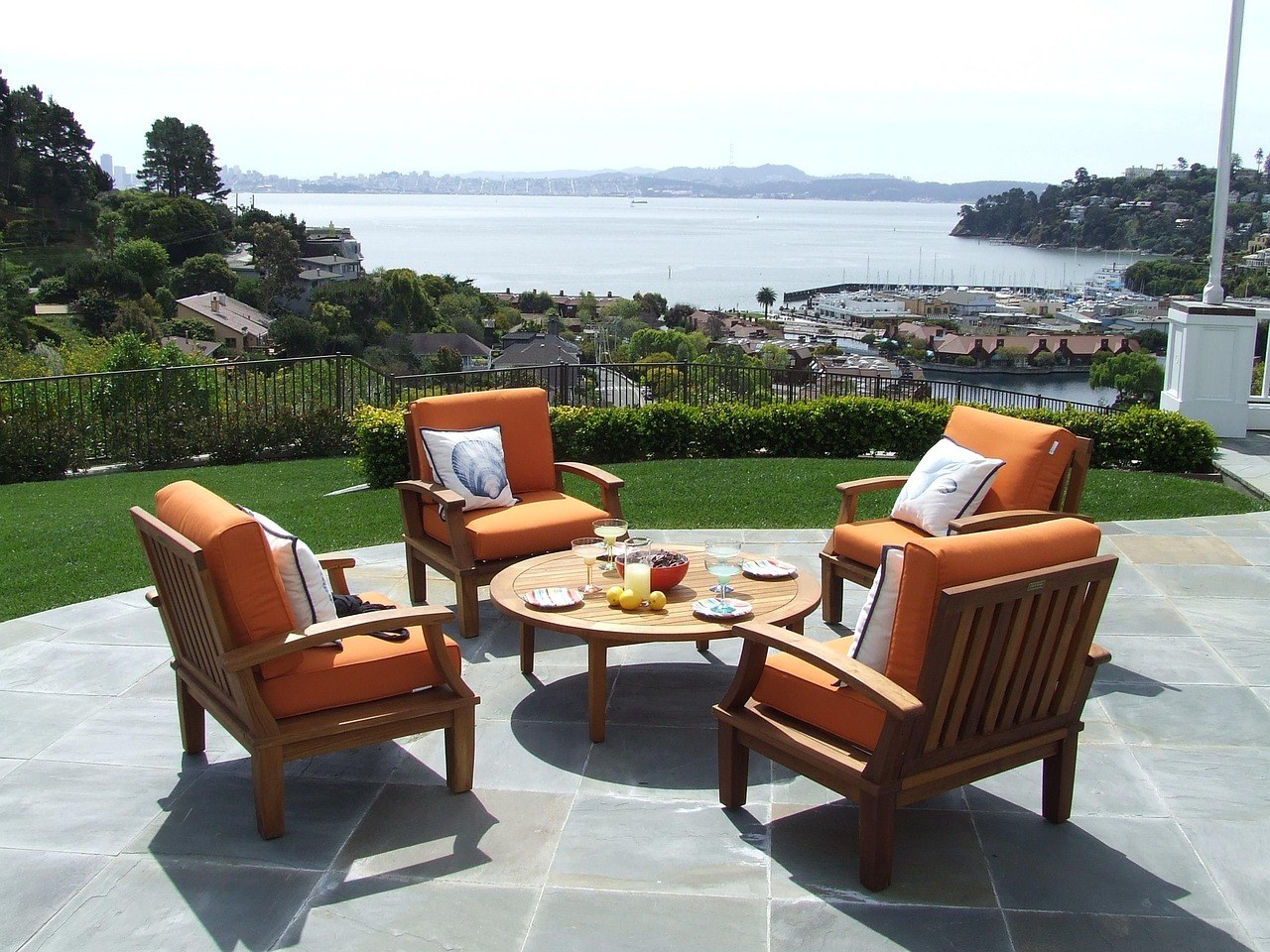 Commercial teak outdoor furniture on a hotel terrace, care and buying guide